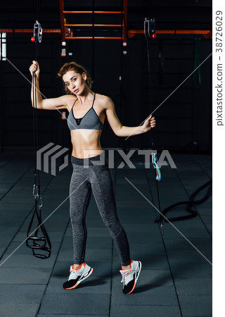 Crossfit woman standing with her front in the gym. 38726029