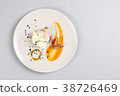 chicken breast with vegetables on a white plate. 38726469
