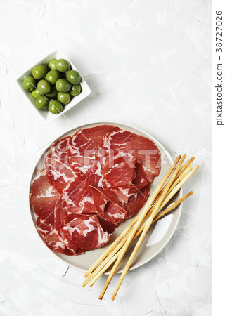 Delicious appetizer with bread sticks and ham 38727026