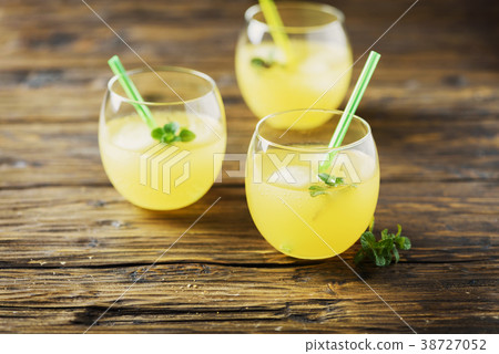 Glasses of orange cocktails with ice and mint 38727052