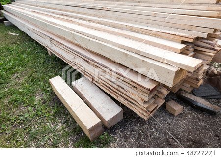 Wooden planks and timbers stacked in pile 38727271