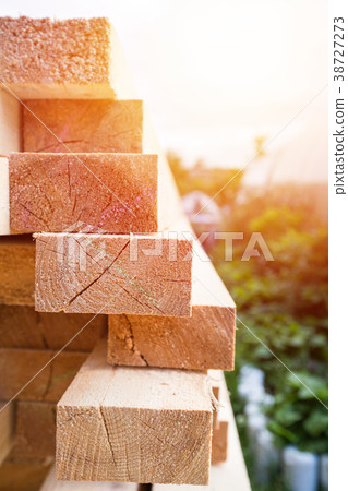 Wooden planks and timbers stacked in pile 38727273