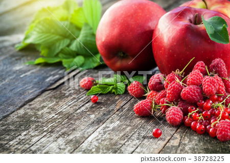 Concept of red berries and fruits on wooden board Concept of red berries and fruits on wooden board 38728225