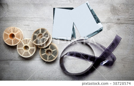 Old photoghraphic film on wood background  38728574