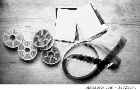 Old photoghraphic film on wood background  38728575