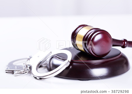 Wooden judge gavel and police handcuffs 38729298
