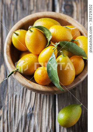 kumquat with green leaves on the wooden table 38729302