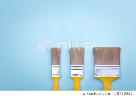 Two brushes for painting on blue paper texture Two brushes for painting on blue paper texture 38729322