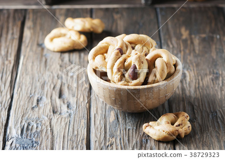 italian tarallo with almonds on the wooden table 38729323