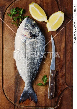Healthy fresh raw fish on the wooden board Healthy fresh raw fish on the wooden board 38730243