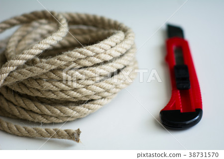Coarse rope roll and a knife with a red handle Coarse rope roll and a knife with a red handle 38731570