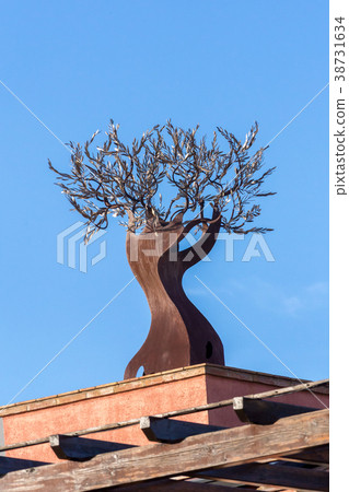 Interesting iron ornament on the top of the house Interesting iron ornament on the top of the house 38731634