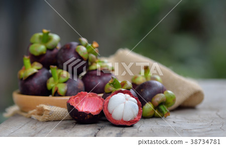 Mangosteen fruit on a wooden table. Mangosteen fruit on a wooden table. 38734781