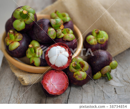 Mangosteen fruit on a wooden table. Mangosteen fruit on a wooden table. 38734854