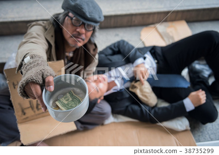 Beggar with drunk Businessman in city 38735299