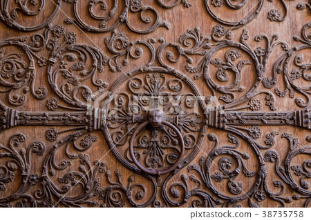 Old wooden door with a metallic pattern close-up Old wooden door with a metallic pattern close-up 38735758