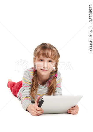 Girl lying on the floor with tablet computer Girl lying on the floor with tablet computer 38736936