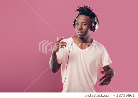 African-American man in headphones listening to 38739661
