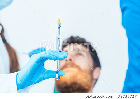 Close-up of the hand of a female dentist holding a Close-up of the hand of a female dentist holding a 38739727