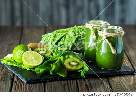 Blended green smoothie with ingredients on the 38740045