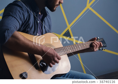 man playing the guitar, close-up 38740116