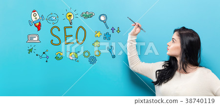 SEO with young woman holding a pen SEO with young woman holding a pen 38740119