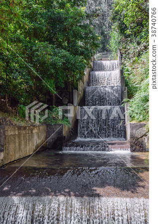 Man made waterfall running down the cascade Man made waterfall running down the cascade 38740766