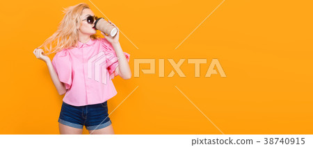 Woman in pink blouse with sunglasses drink coffee Woman in pink blouse with sunglasses drink coffee 38740915