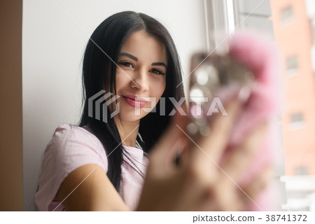 Glamour pregnant woman make selfie in window light Glamour pregnant woman make selfie in window light 38741372