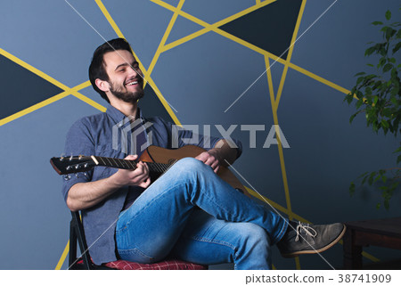 a cheerful man with a guitar a cheerful man with a guitar 38741909