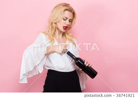 Blonde woman open wine bottle with corkscrew 38741921