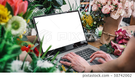 Woman using interface of flower shop 38742002