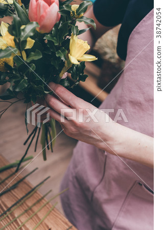 Florist making beautiful bouquet Florist making beautiful bouquet 38742054