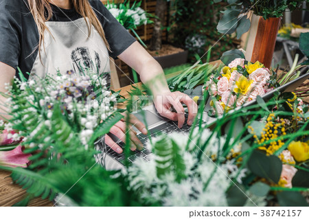 Florist working in modern flower shop Florist working in modern flower shop 38742157