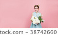 Beautiful woman with a bunch of flowers on a pink 38742660