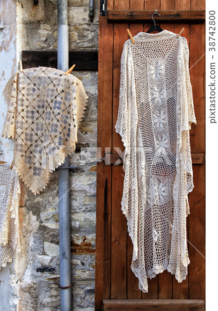 Hand made laces and needlework hang on shop wall Hand made laces and needlework hang on shop wall 38742800