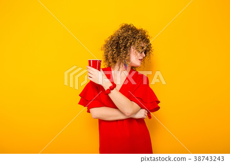 Attractive woman with short curly hair and drink 38743243