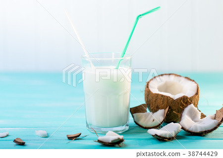 Glass of coconut milk on blue wooden table 38744429