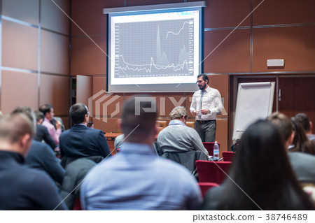 Skiled Public Speaker Giving a Talk at Business 38746489