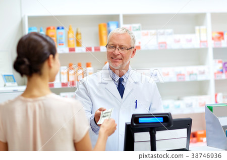 customer giving money to pharmacist at drugstore customer giving money to pharmacist at drugstore 38746936