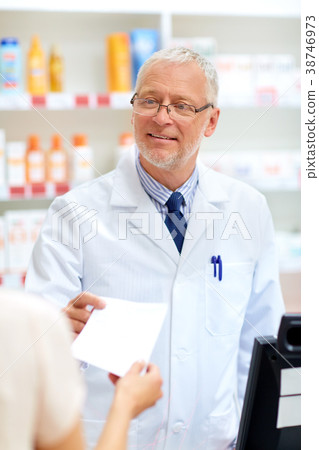 senior apothecary with prescription at pharmacy 38746973