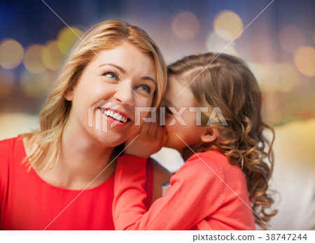happy mother and girl whispering into ear 38747244