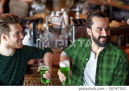 male friends drinking green beer at bar or pub 38747301