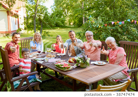happy family having dinner or summer garden party 38747474