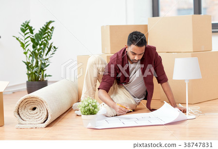 man with blueprint and boxes moving to new home man with blueprint and boxes moving to new home 38747831