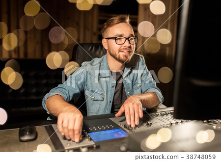 man at mixing console in music recording studio 38748059
