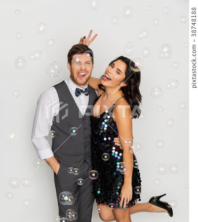 happy couple hugging in soap bubbles at party happy couple hugging in soap bubbles at party 38748188