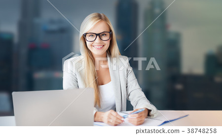 businesswoman with notepad and laptop at office 38748258