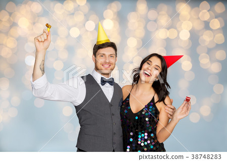 happy couple with party blowers having fun 38748283