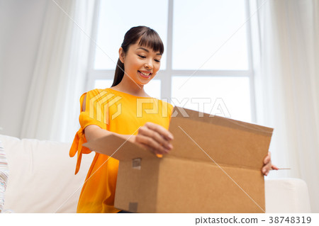 happy asian young woman with parcel box at home 38748319